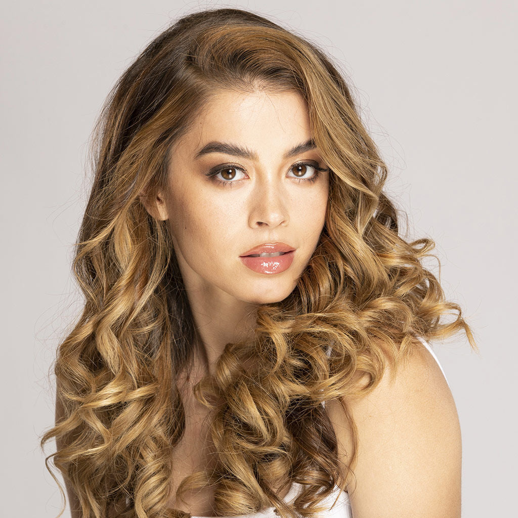 Woman with long, wavy hair against a plain background