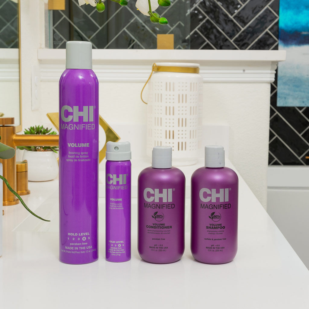Set of CHI Magnified Volume hair care products on a bathroom counter.
