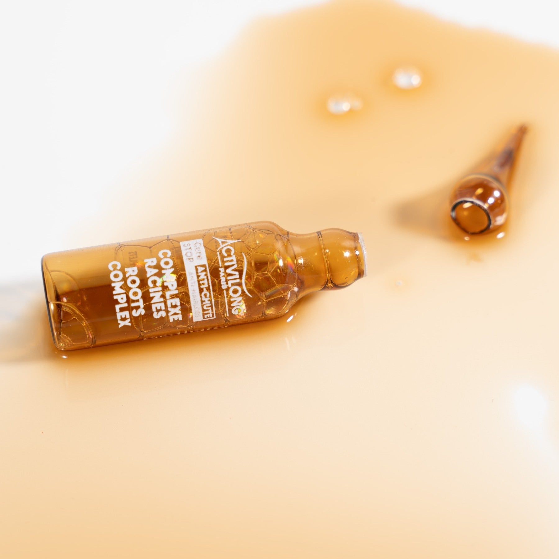 ACTIVILONG ACTIGRO Complexe Racines 30ml Hair Serum with a dropper on a beige background