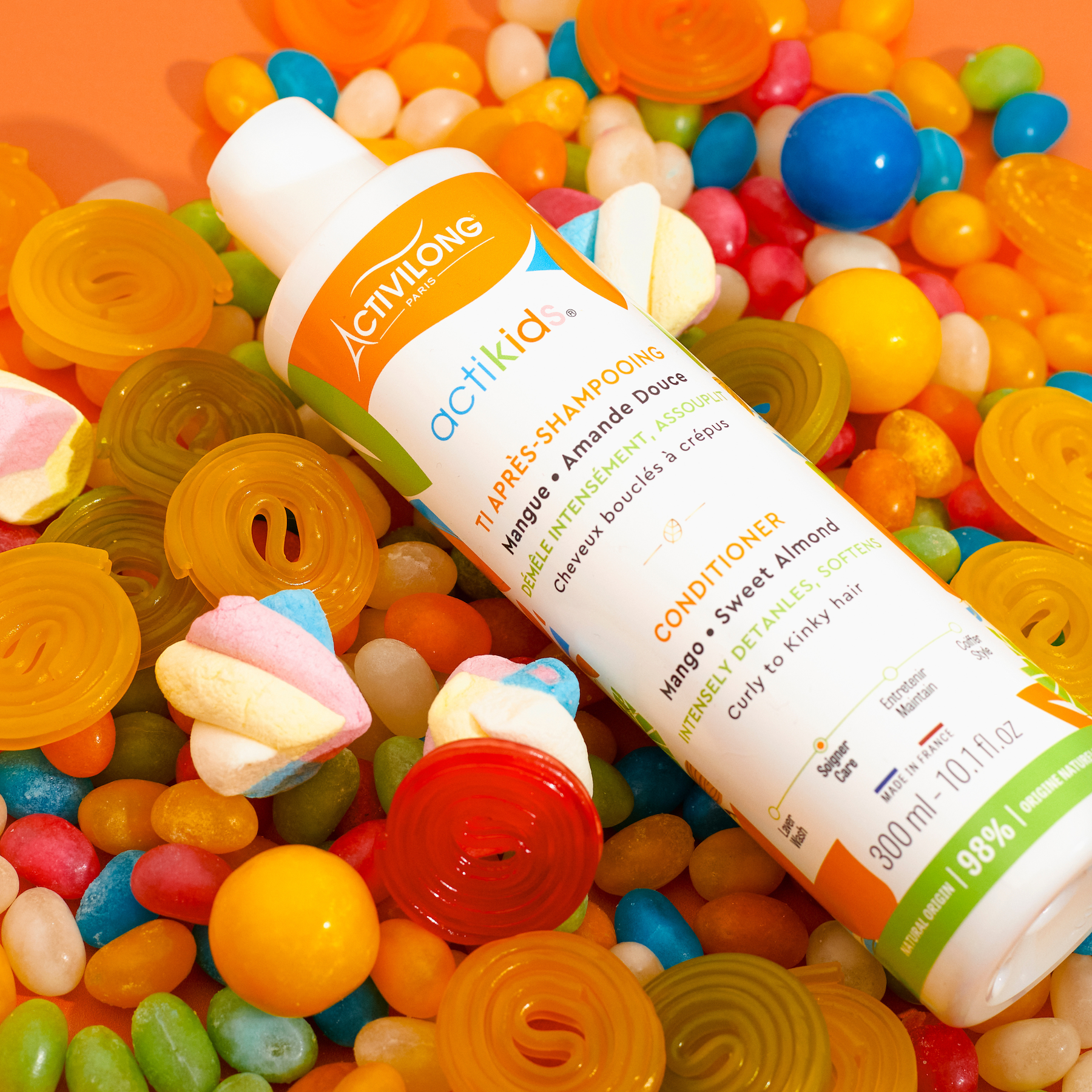 ACTIVILONG ACTIKIDS Conditioner Après-Shampoing 250ml bottle by ABS France Wholesale surrounded by colorful candies