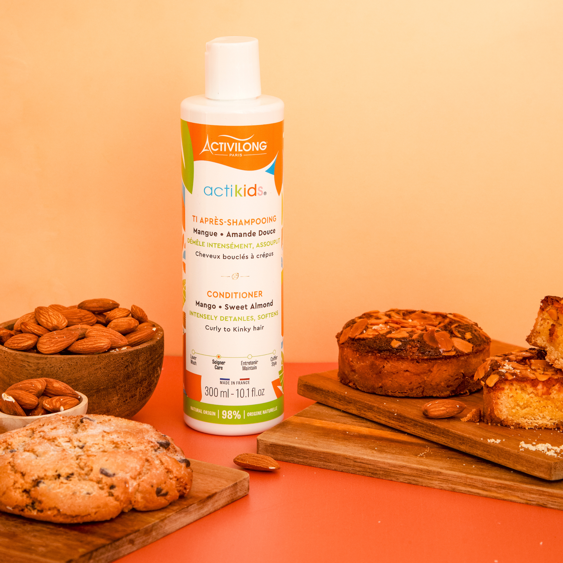 ACTIVILONG ACTIKIDS Conditioner Après-Shampoing 250ml bottle by ABS France Wholesale on a wooden surface with cookies and almonds