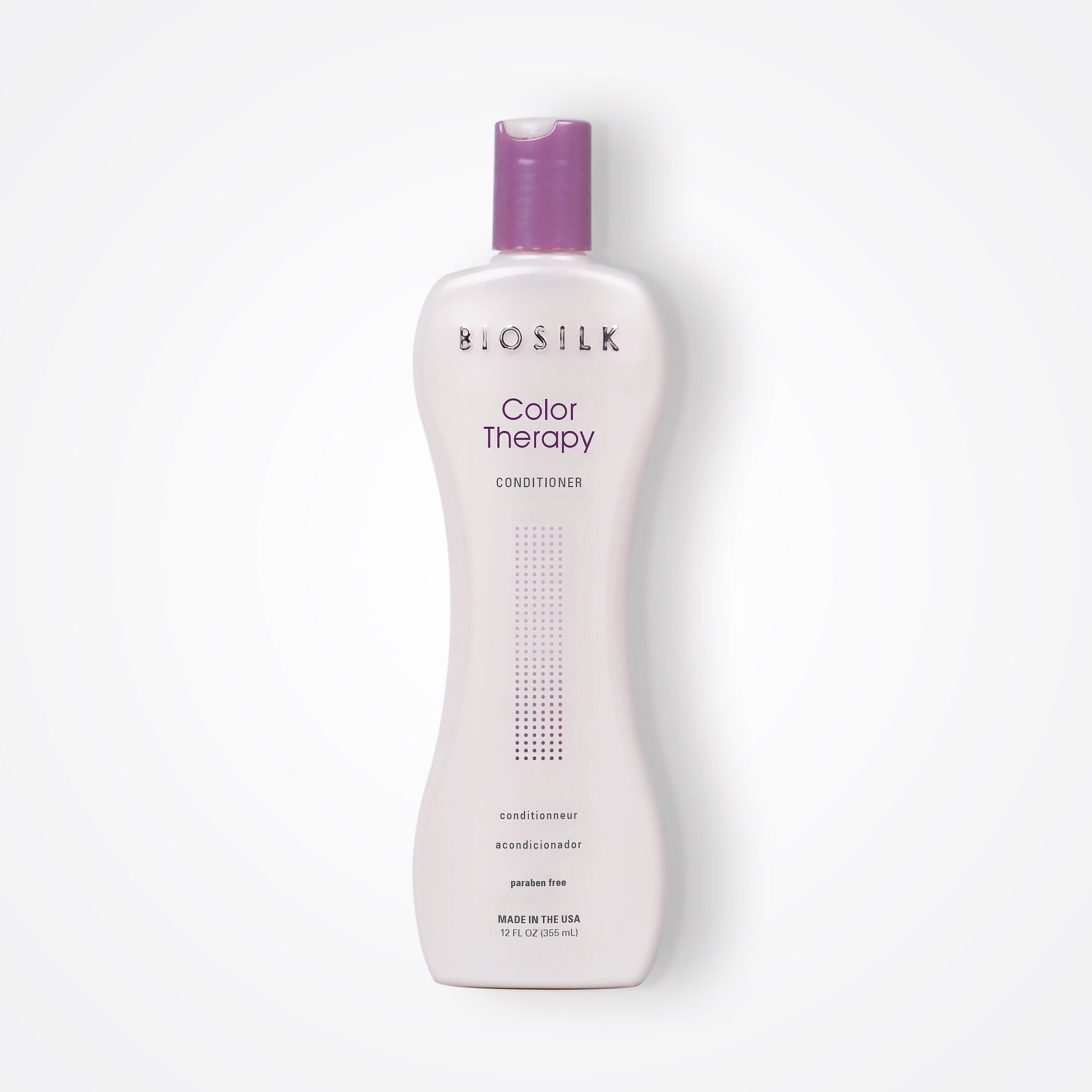 A bottle of BIOSILK Color Therapy Conditioner, featuring a pale pink body and a lavender-purple cap, set against a clean white background.
