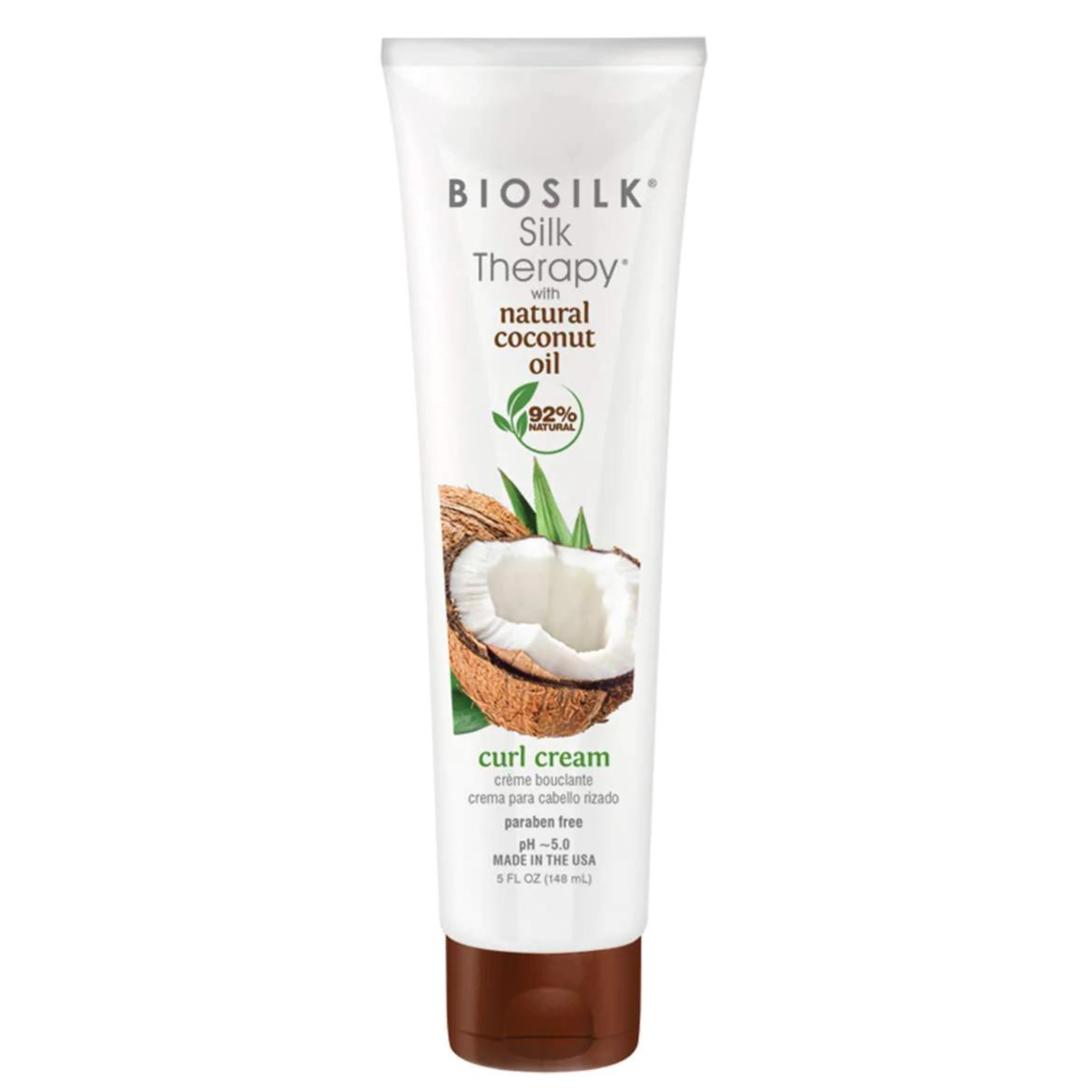 Biosilk Silk Therapy with natural coconut oil curl cream in a white squeeze tube with a brown cap, featuring a coconut graphic on the front.