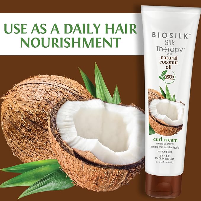 Biosilk Silk Therapy curl cream tube shown next to a large coconut illustration on a brown background, with green text reading 'USE AS A DAILY HAIR NOURISHMENT' and leaves around the coconut.