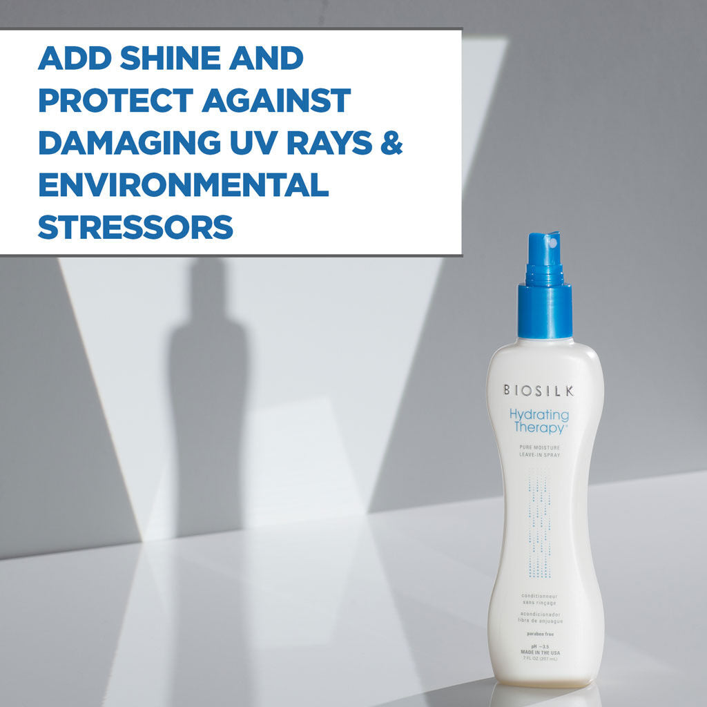 Biosilk Hydrating Therapy UV protection spray bottle on a reflective gray surface with a text overlay in the top left that reads 'ADD SHINE AND PROTECT AGAINST DAMAGING UV RAYS & ENVIRONMENTAL STRESSORS'.