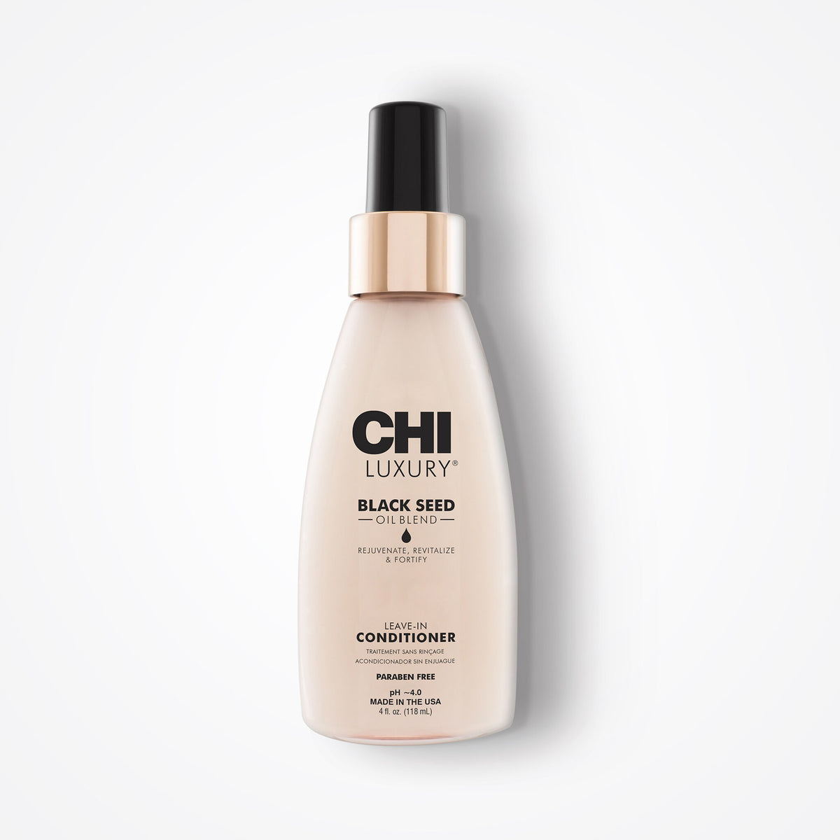CHI Luxury Black Seed Oil Infused Conditioner bottle, featuring a pale beige body, a metallic rose gold collar, and a black spray nozzle, set against a clean white background.