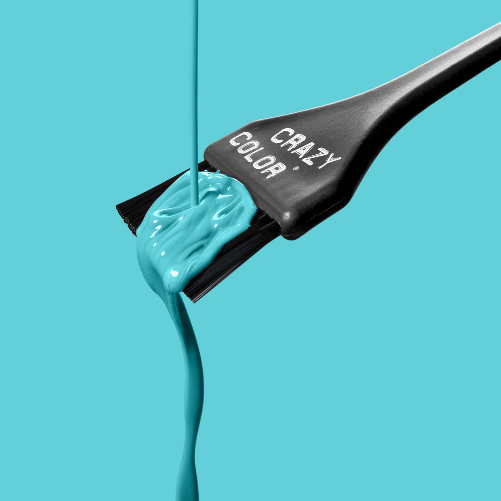 Crazy Color Hair dye brush with Bubblegum Blue colorant on a turquoise background by ABS France Wholesale