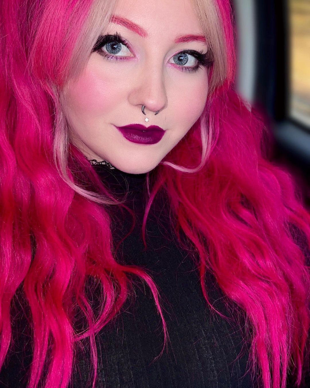 Crazy Color's Person with bright pink hair and dark lipstick looking directly at the camera - ABS France Wholesale