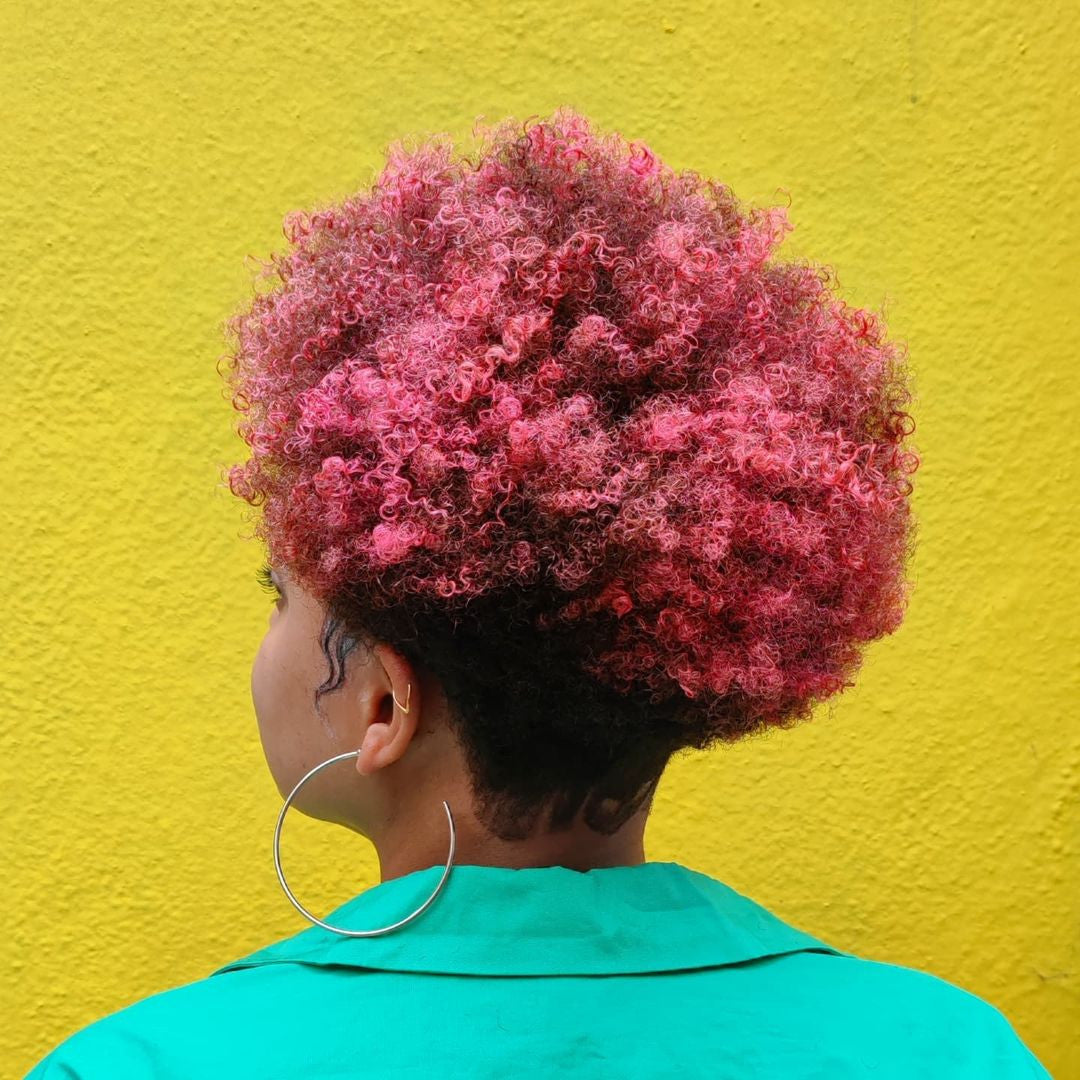 Crazy Color's Person with pink and black hair against a yellow wall by ABS France Wholesale