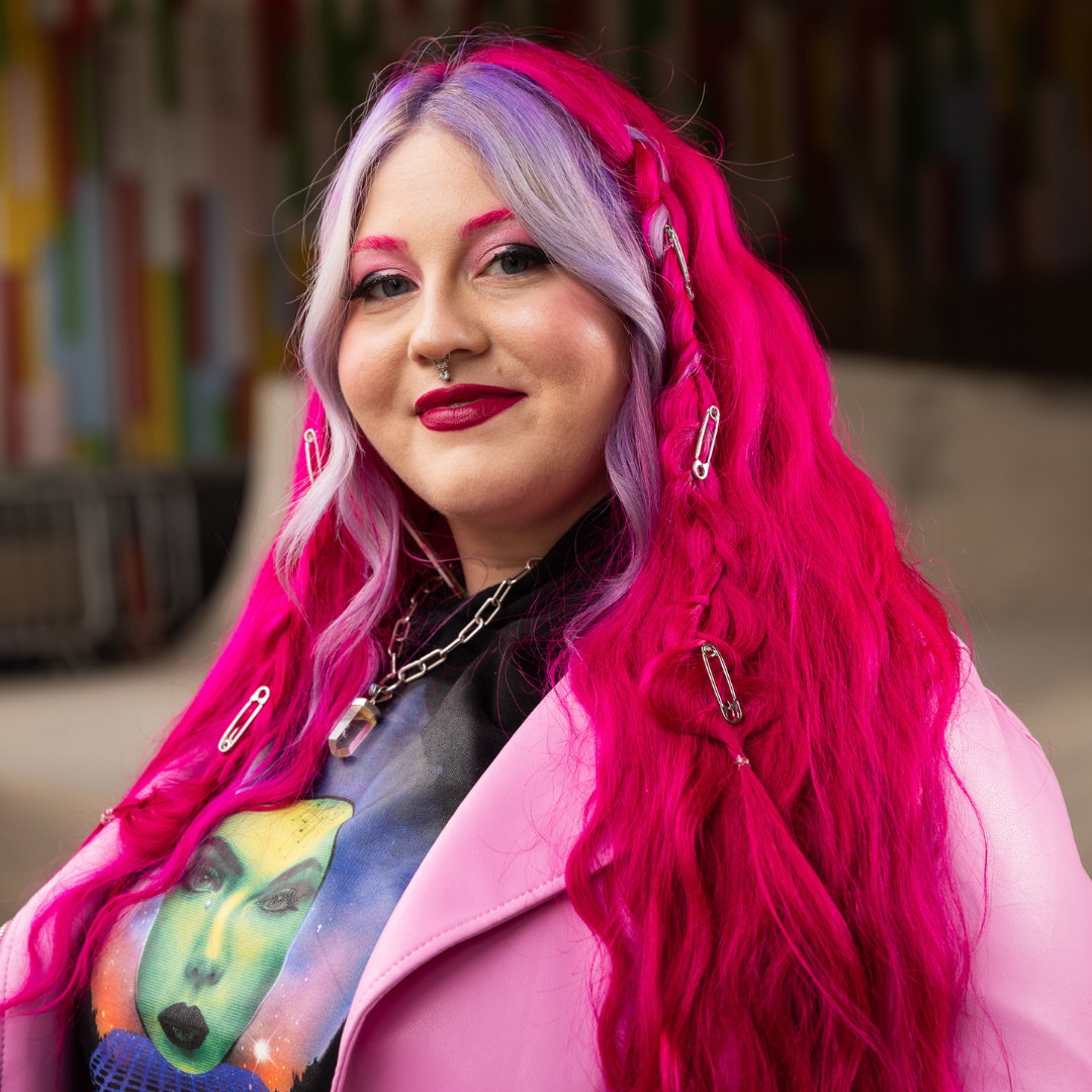 Crazy Color's Person with vibrant pink hair and colorful clothing in a casual setting - ABS France Wholesale