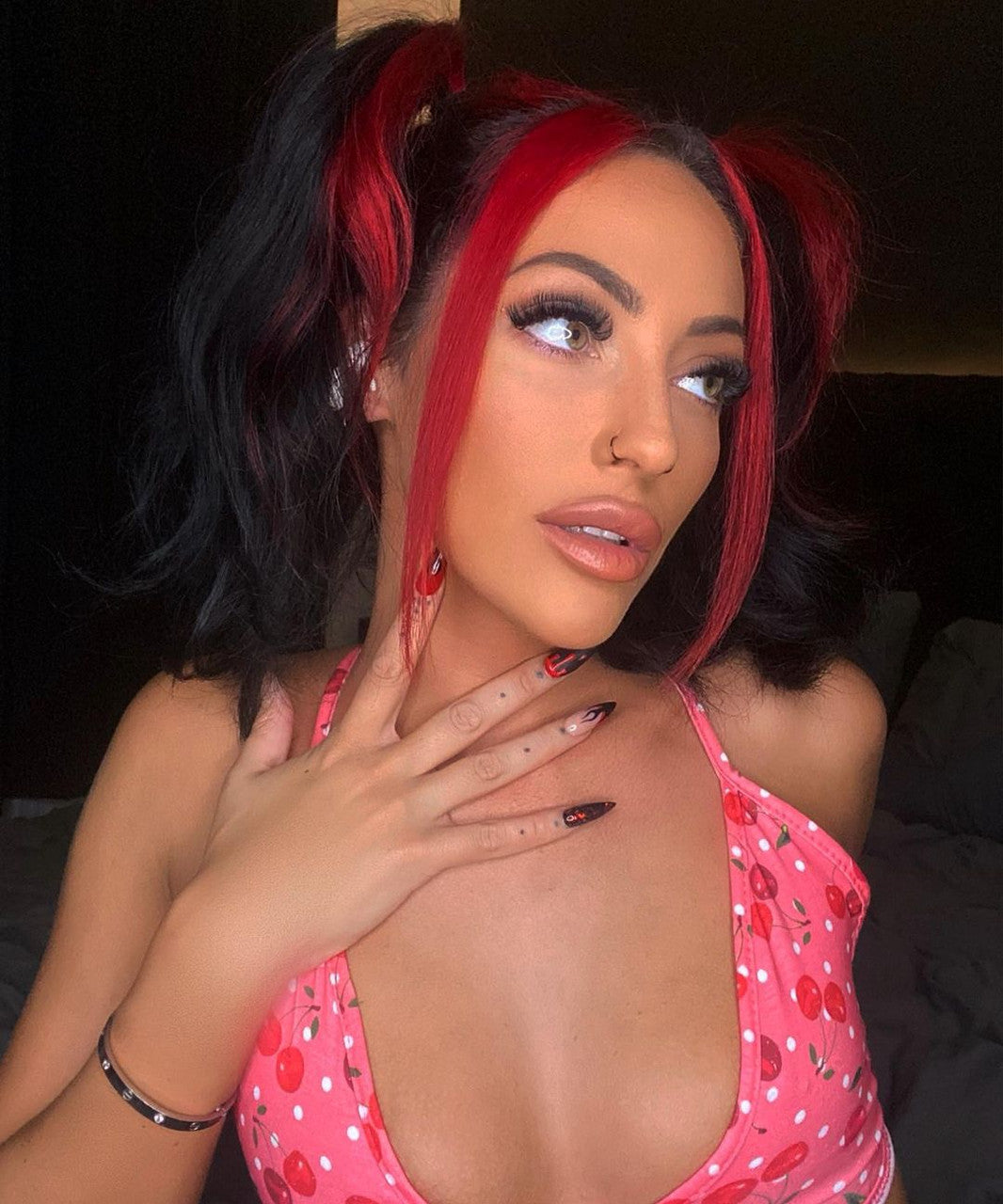 Crazy Color's person with red and black hair and nails and wearing pink bra by ABS France Wholesale