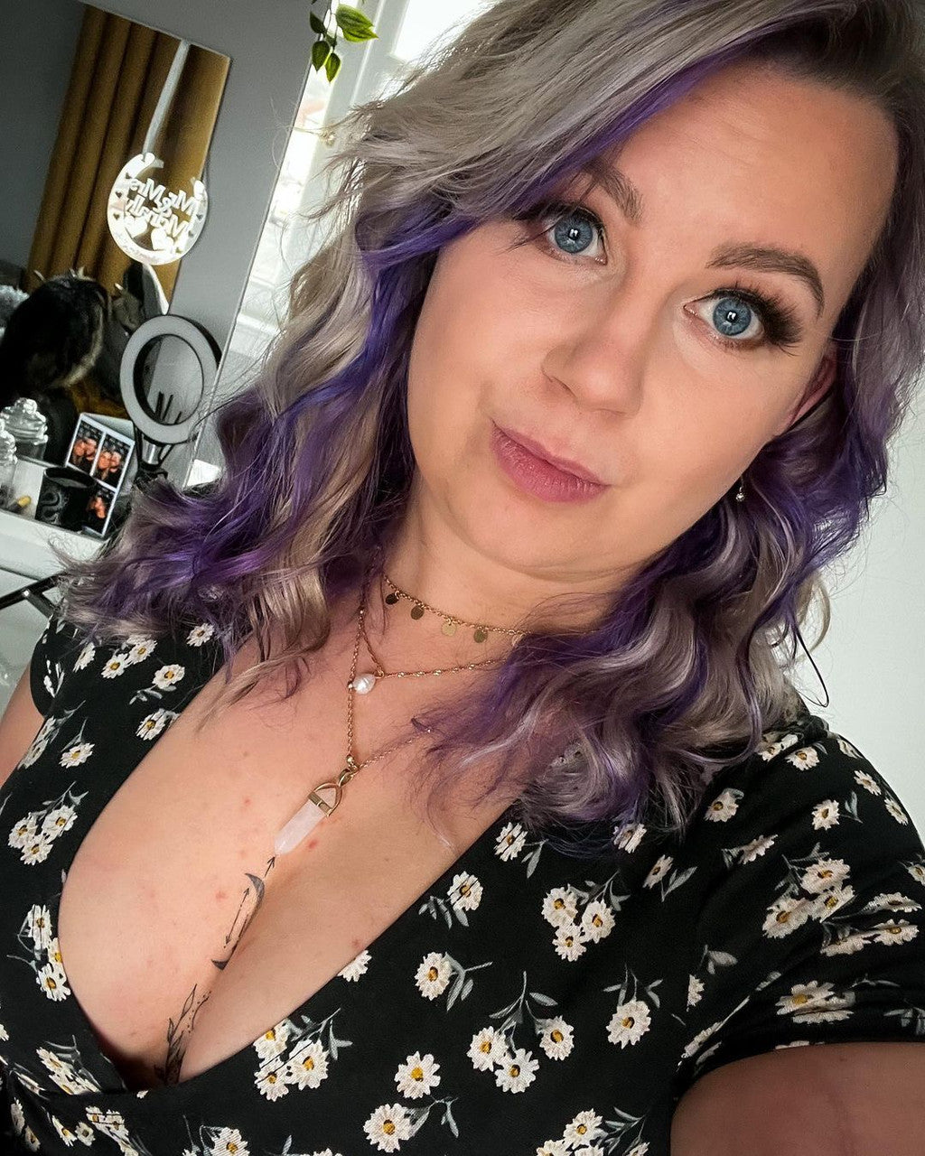 Crazy Color's person with purple hair and floral dress in a room setting by ABS France Wholesale
