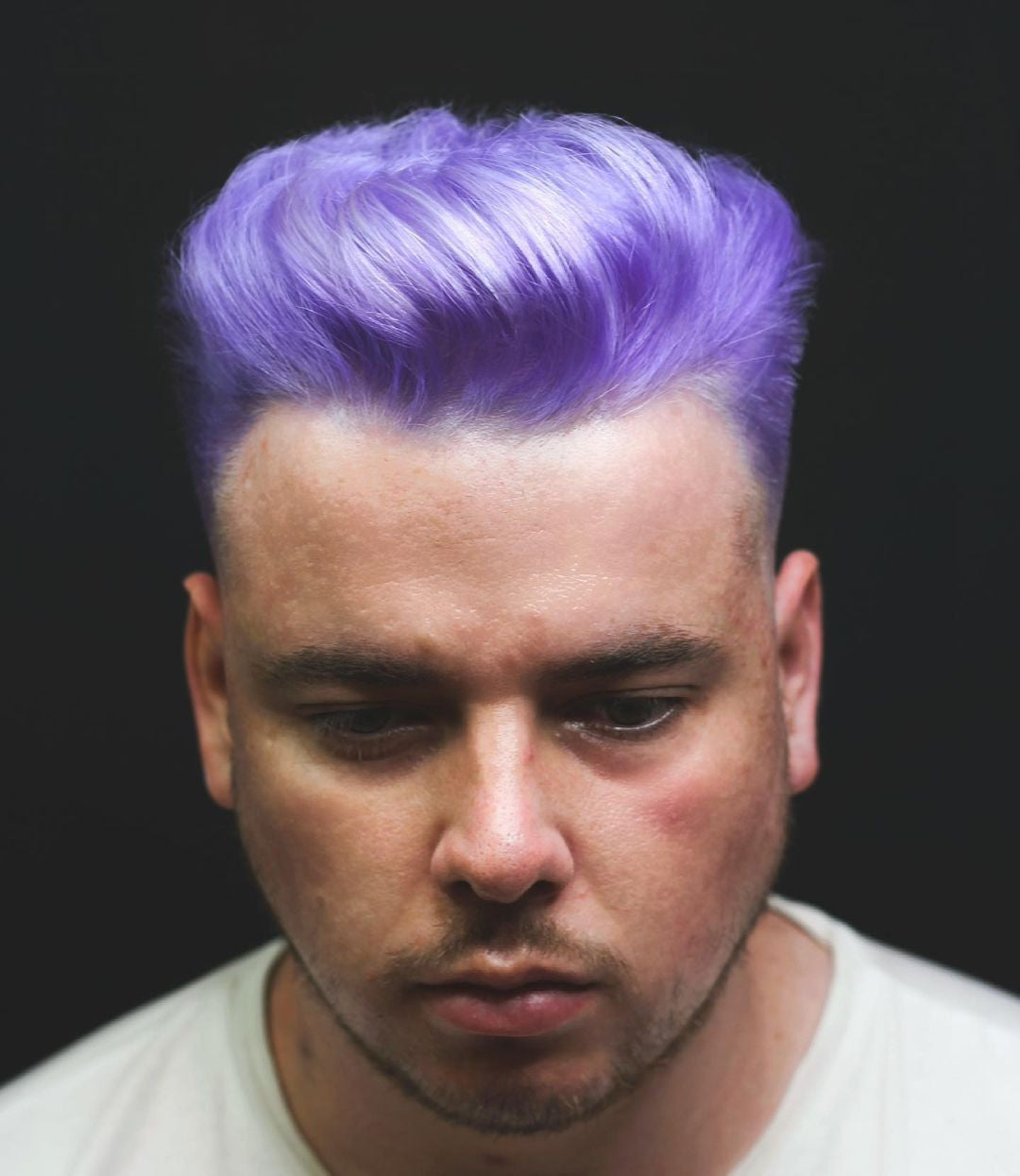 Crazy Color's Person with purple hair against a black background by ABS France Wholesale