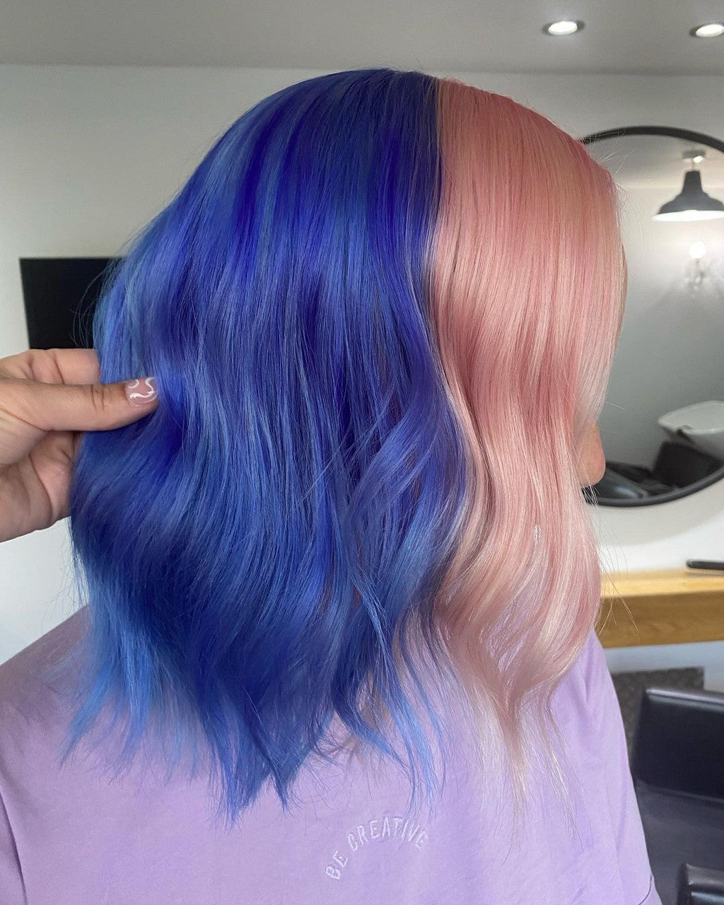 Crazy Color's Person with blue and pink hair in a salon setting by ABS France Wholesale