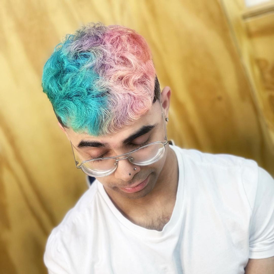 Crazy Color's Person with colorful hair and glasses against a gold background by ABS France Wholesale