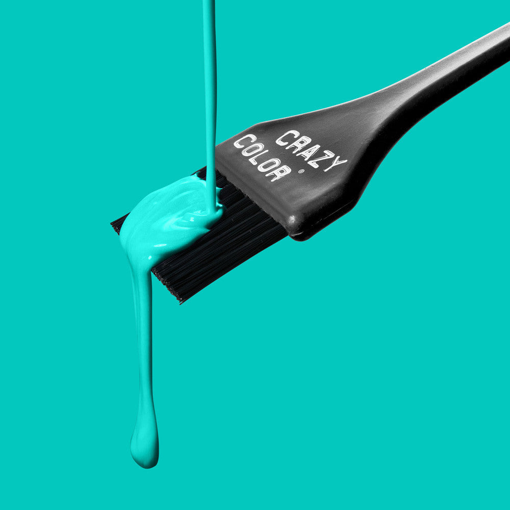 Crazy Color Peppermint 71 hair dye being applied with a 'Crazy Color' brush on a teal background by ABS France Wholesale
