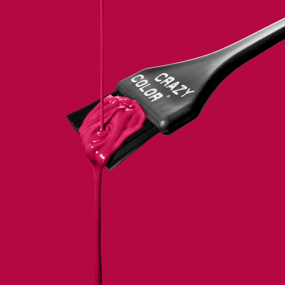 Black hairbrush with Crazy Color Ruby Rouge 66 hair dye on a pink background, featuring the 'Crazy Color' brand by ABS France Wholesale