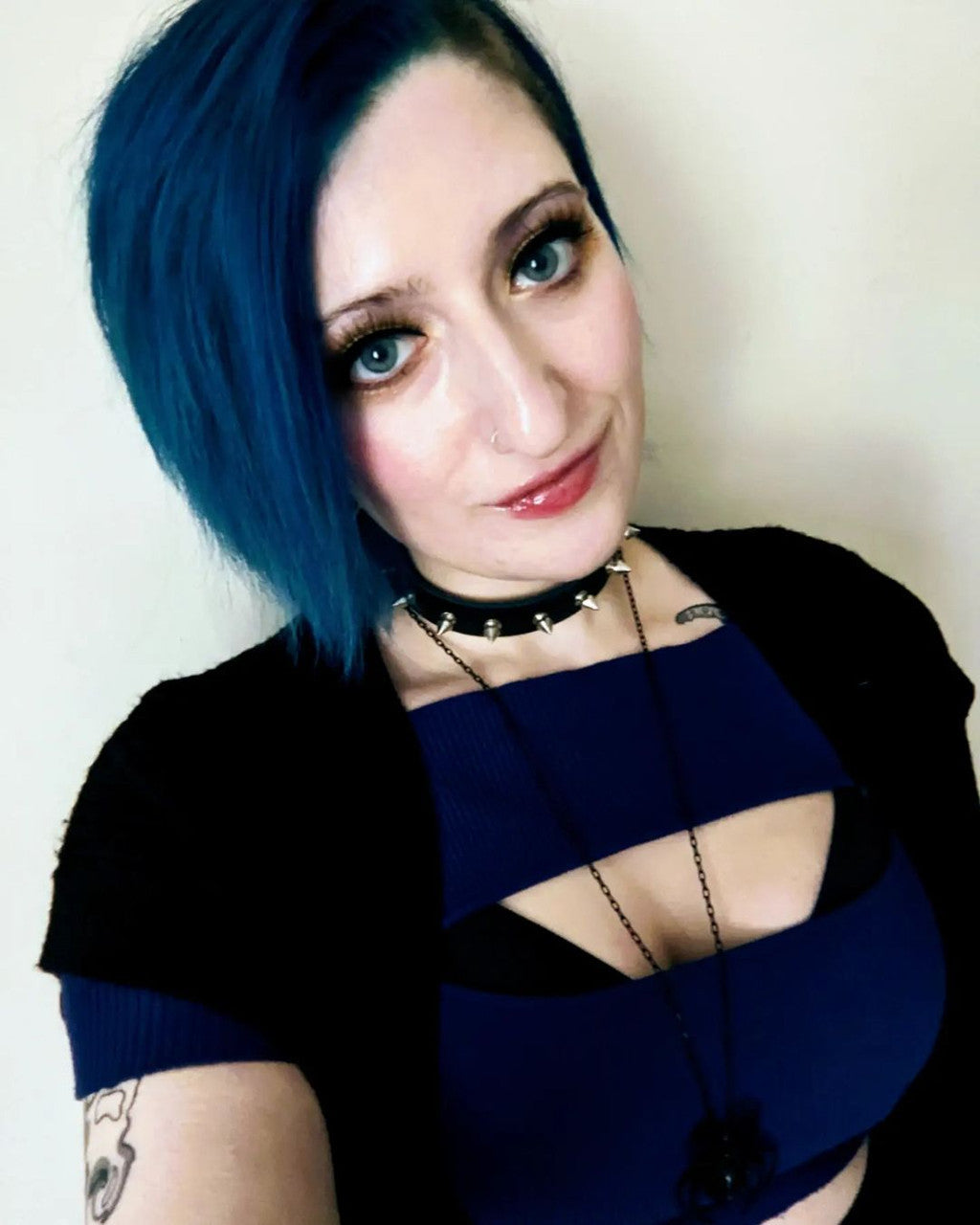 Crazy Color's Person with blue hair wearing a black top with cut-out design against a plain background by ABS France Wholesale