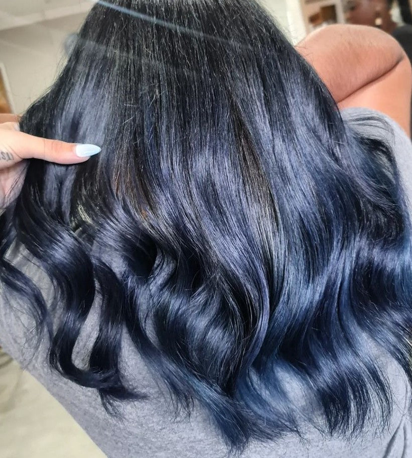 Crazy Color's person Close-up of blue hair extensions being held by a person by ABS France Wholesale