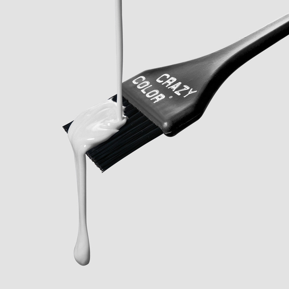 Crazy Color Silver 27 Hair color brush with white dye dripping from it on a light gray background by ABS France Wholesale