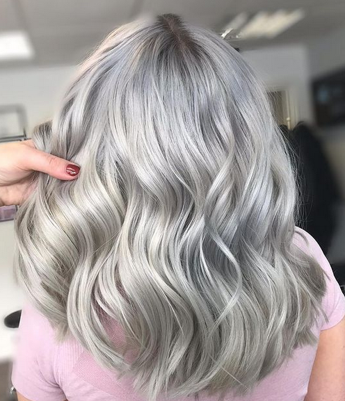 Crazy Color's Person with wavy silver hair in a salon setting by ABS France Wholesale