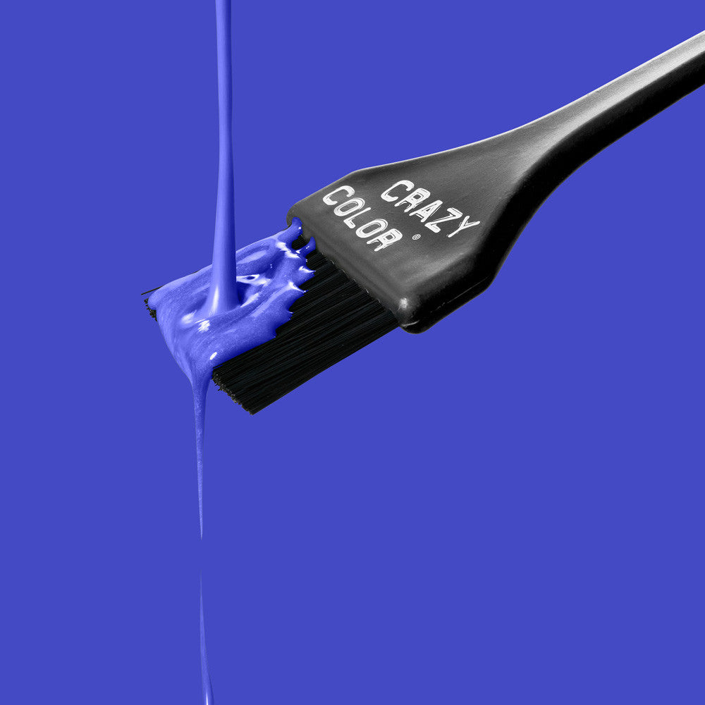 Black hair dye brush with Crazy Color's Sky Blue colorant on a blue background by ABS France Wholesale