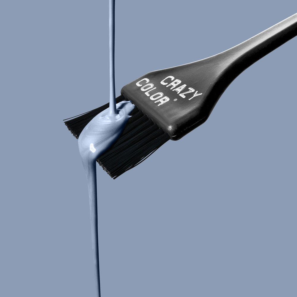 Crazy Color Slate Hair dye brush with slate colorant dripping from it against a blue background by ABS France Wholesale