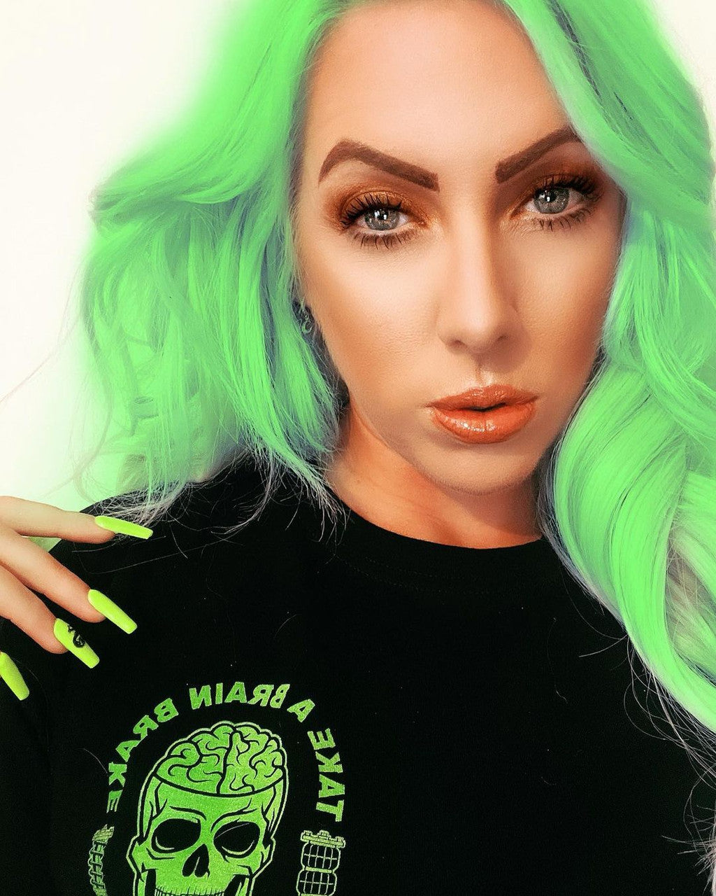 Crazy Color's Person with green hair and black shirt featuring a green graphic design by ABS France Wholesale