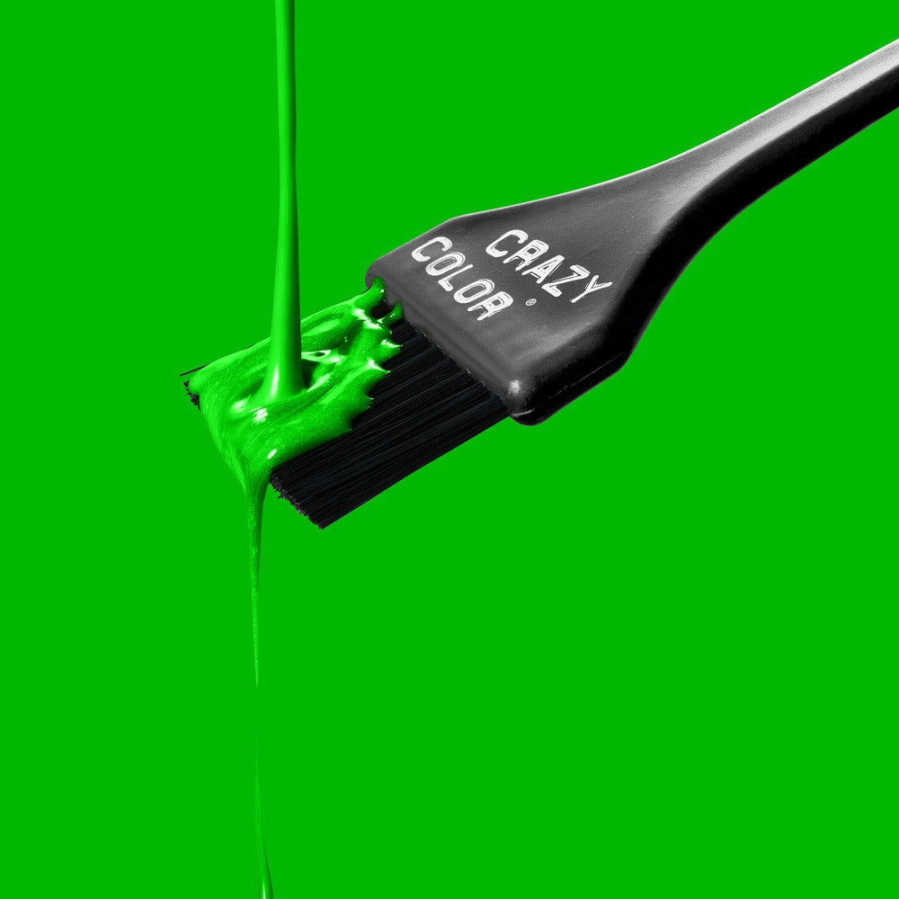 Crazy Color Toxic UV 79 hair dye liquid with Black hairbrush with 'Crazy Color' branding on a green background by ABS France Wholesale