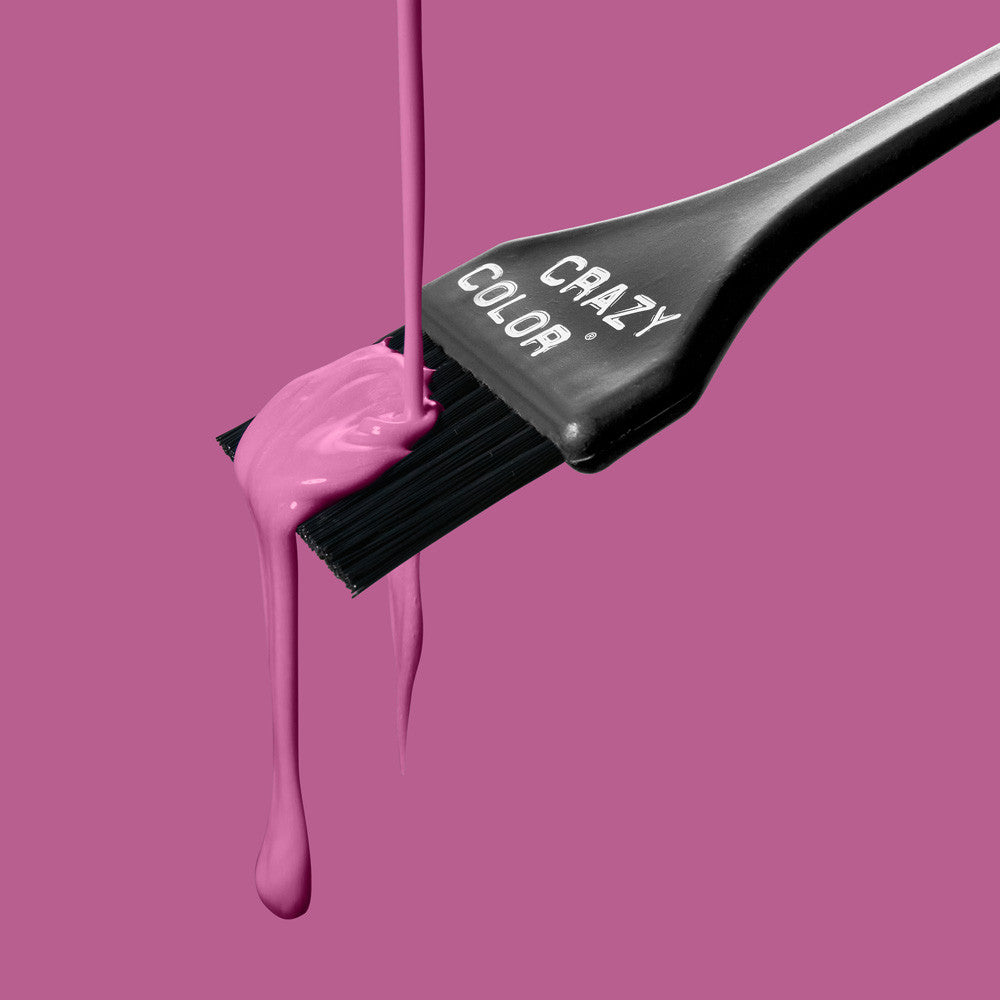 Crazy Color Hair dye brush with pink colorant dripping from it on a pink background by ABS France Wholesale