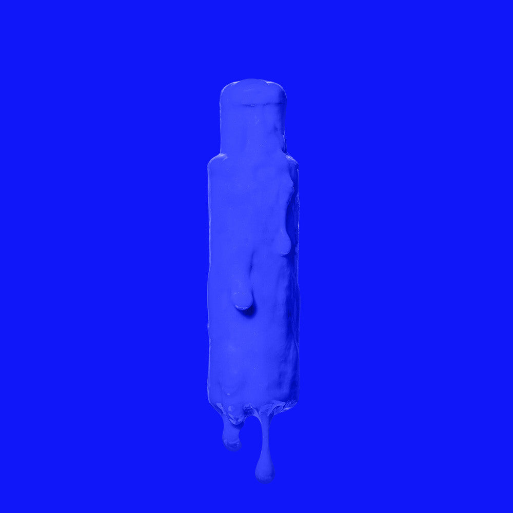 Crazy Color's Capri Blue bottle with a droplet effect on a blue background by ABS France Wholesale