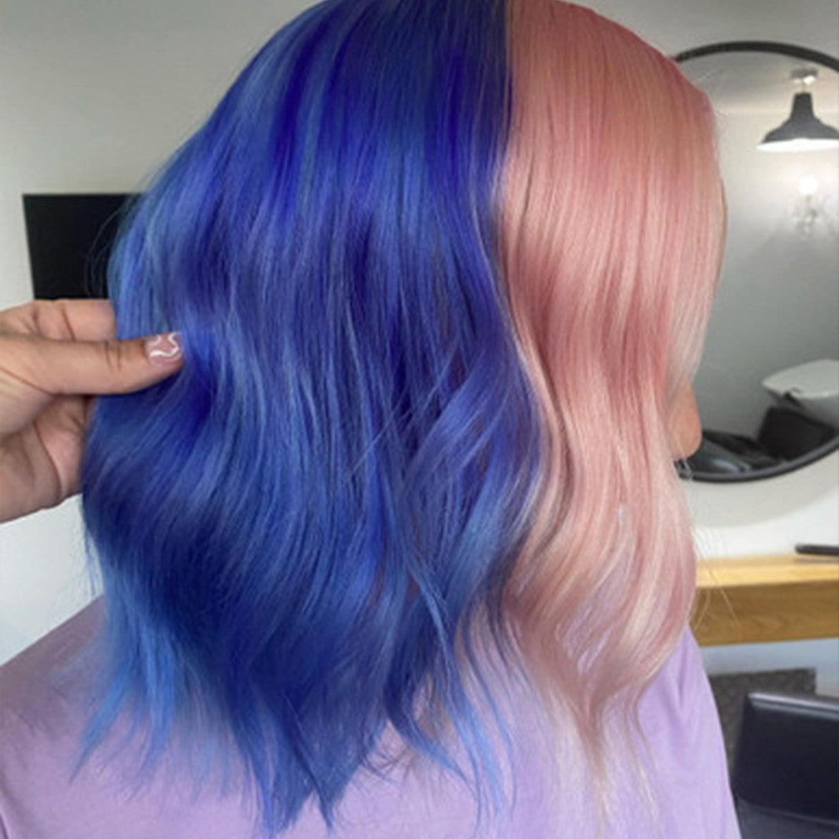 Crazy Color's Person with blue and pink hair in a salon setting by ABS France Wholesale