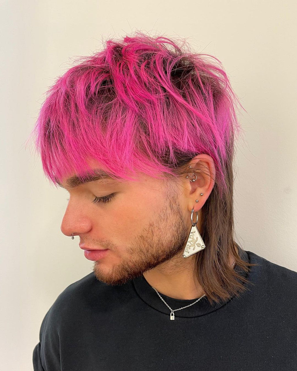 Crazy Color's Person with pink and brown hair wearing a black shirt against a plain background by ABS France Wholesale