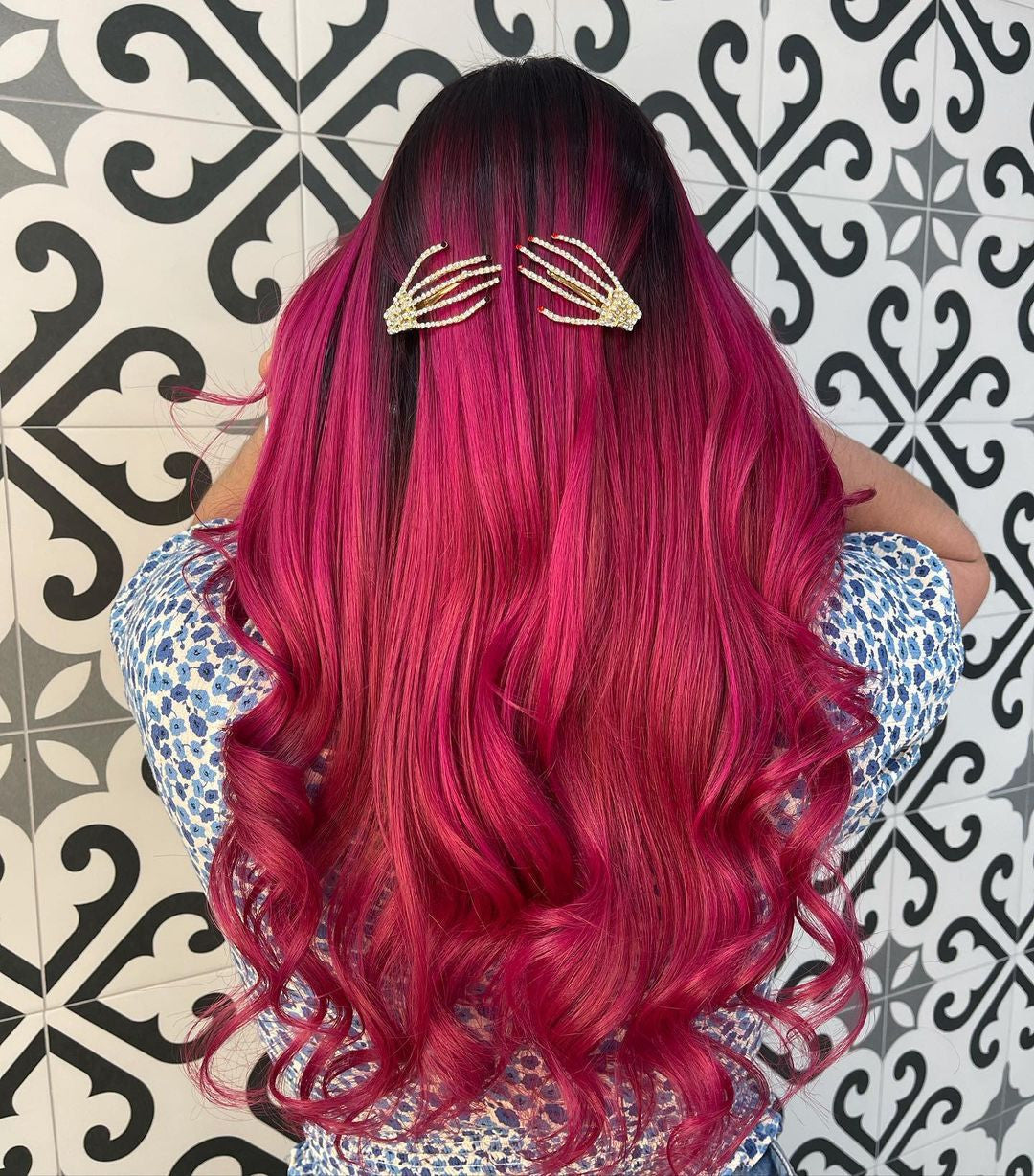 Crazy Color's Person with vibrant pink hair wearing gold hair clips against a patterned wall - ABS France Wholesale