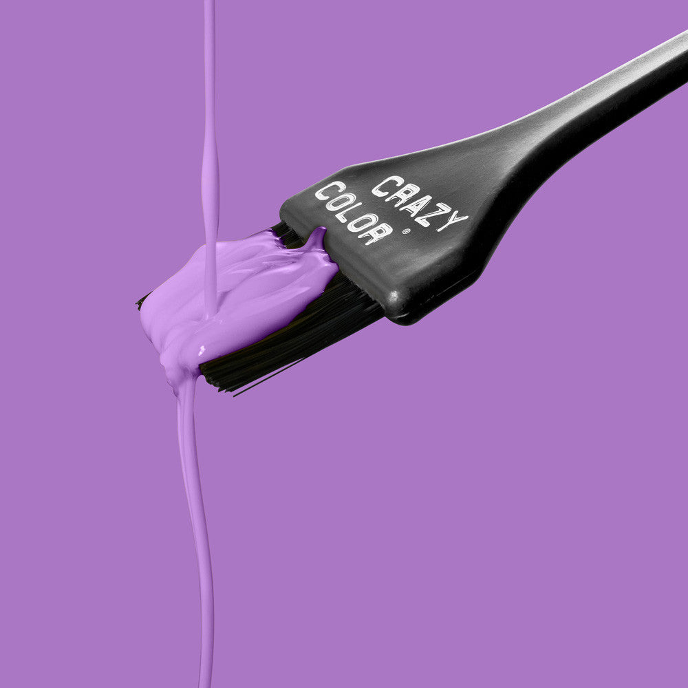 Hair dye brush with Crazy Color Lavender no. 54 colorant on a purple background, featuring the brand 'Crazy Color' by ABS France Wholesale