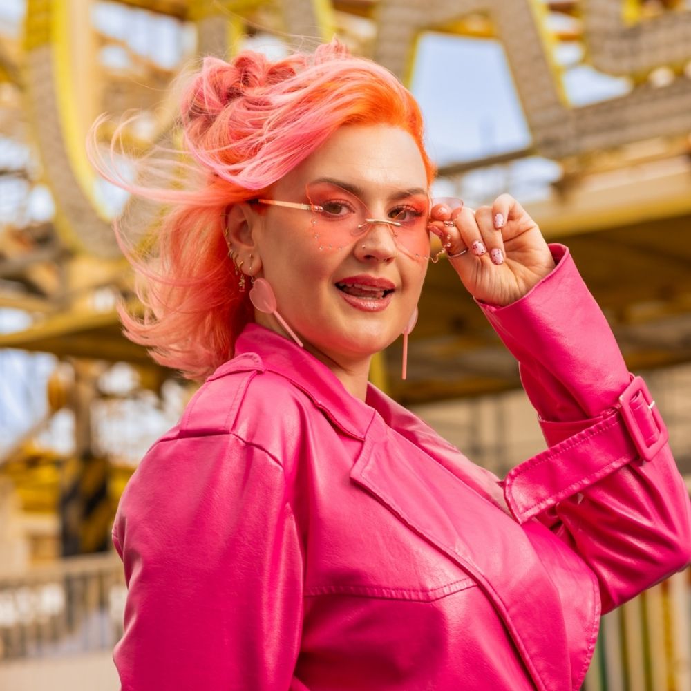 Crazy Color's Person with pink hair and pink jacket standing in front of a blurred background by ABS France Wholesale