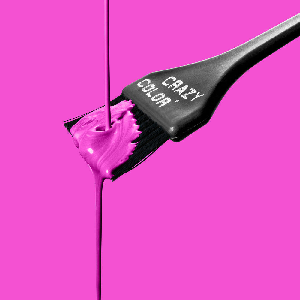 Hair dye brush with pink color on a bright pink background, featuring the brand 'Crazy Color' by ABS France Wholesale