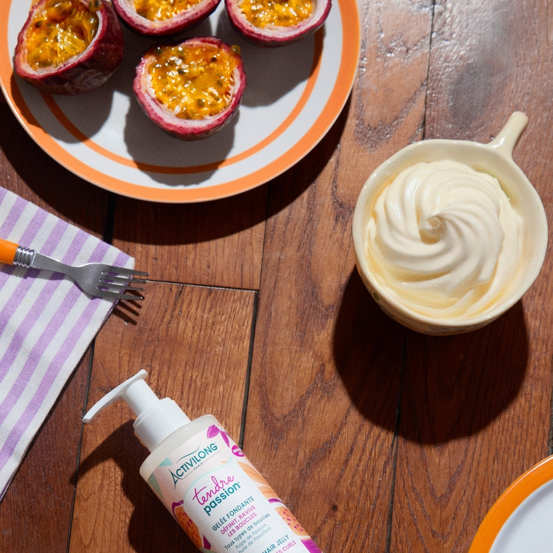 Bowl of whipped cream, plate with passion fruit slices, Bottle of ACTIVILONG TENDRE PASSION Gelée Fondante 260ml by ABS France Wholesale on a wooden table
