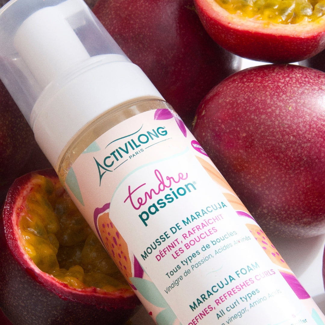 ACTIVILONG TENDRE PASSION Mousse de Maracuja 200ml foam bottle by ABS France Wholesale with passion fruit on a wooden surface