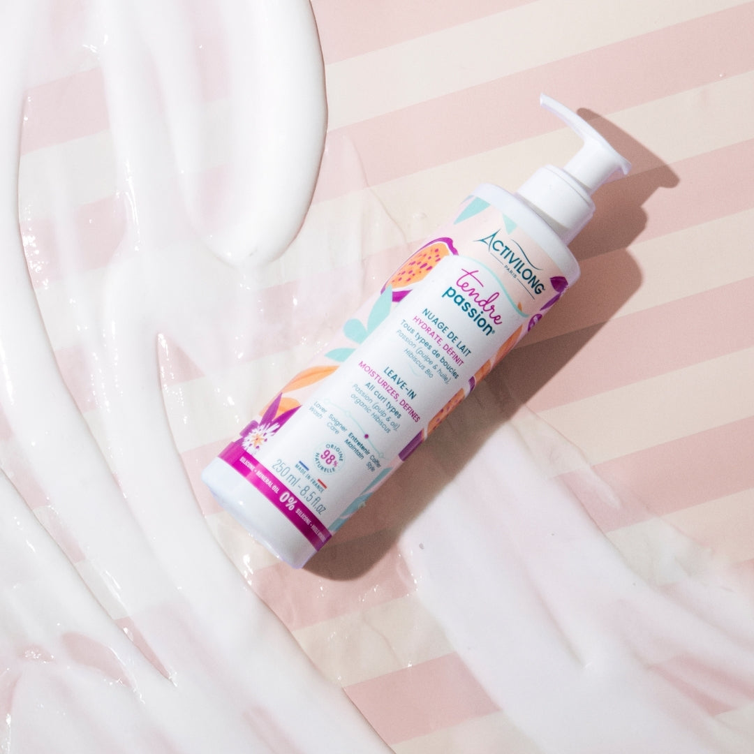 bottle of ACTIVILONG TENDRE PASSION Nuage de Lait 250ml by ABS France Wholesale on a soft pink fabric background