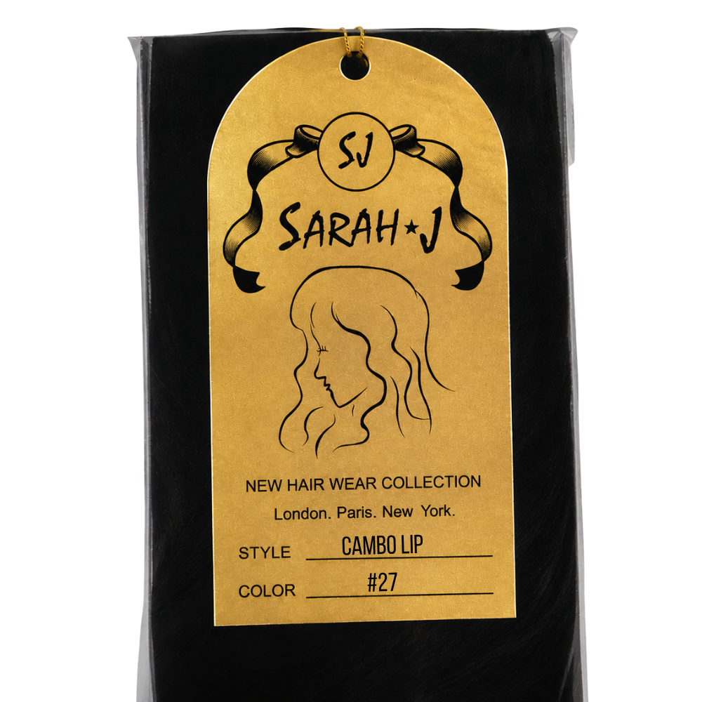 A packaged hair product shown in a black pouch with a large gold hanging tag. The tag reads 'Sarah J' and 'New Hair Wear Collection' with 'Style: Cambo Lip' and 'Color: #27'.