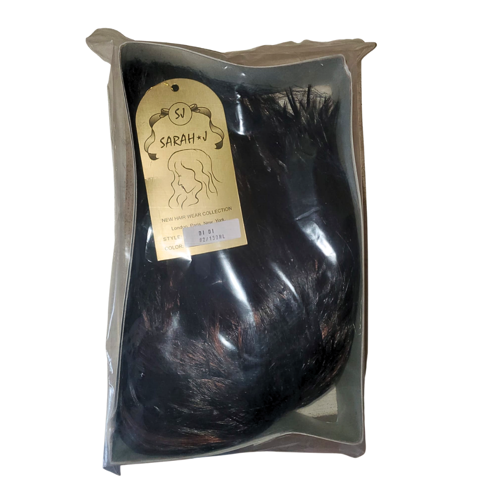 Packaged hair extensions with a label on a white background