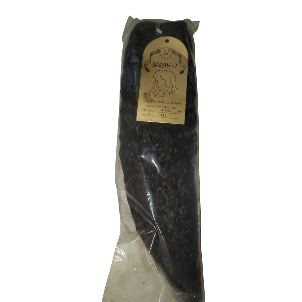 Packaged black hair extensions with a gold label on a white background