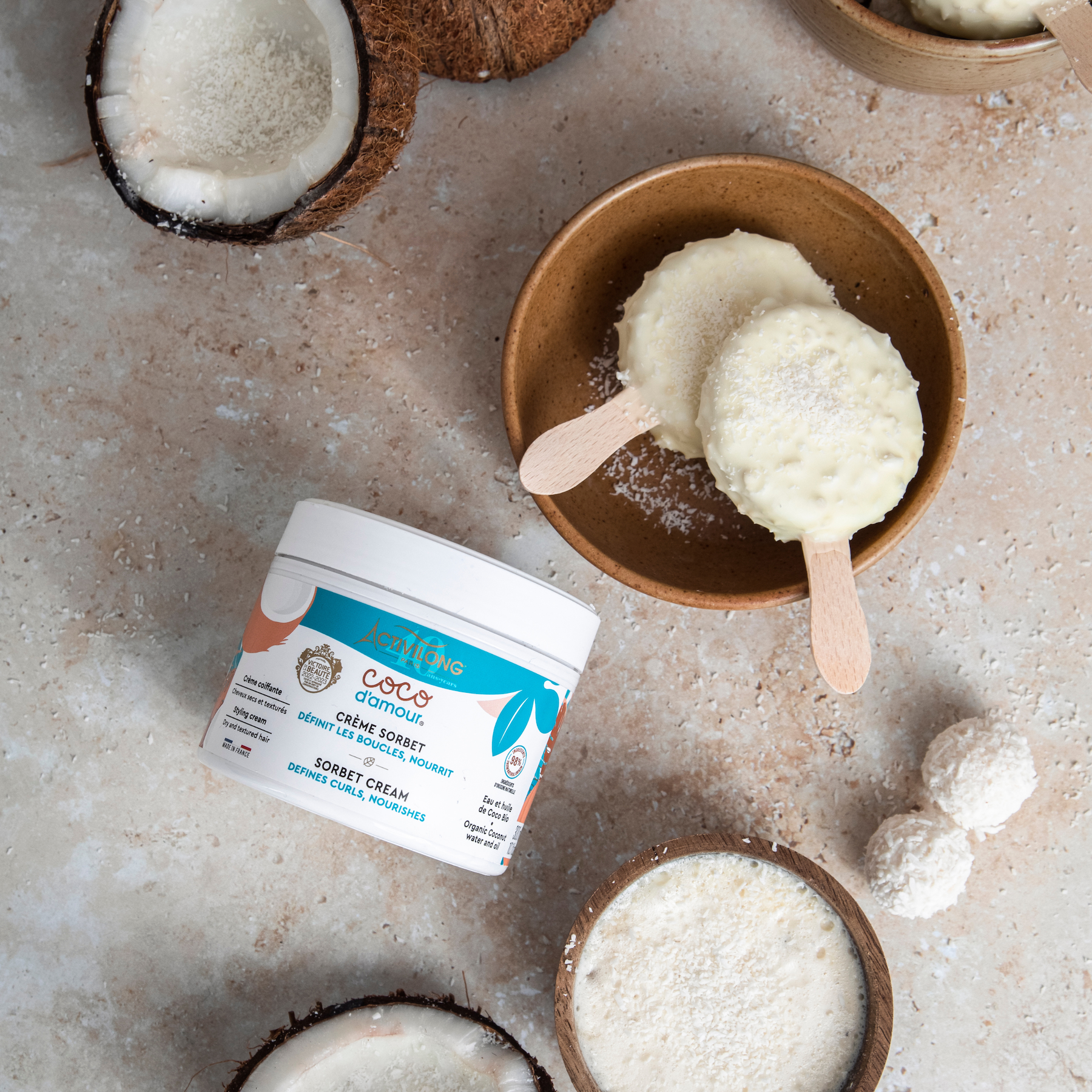 Coconut-based dessert cream with an ACTIVILONG COCO D’AMOUR Crème Sorbet 300ml Jar by ABS France Wholesale on a textured surface.