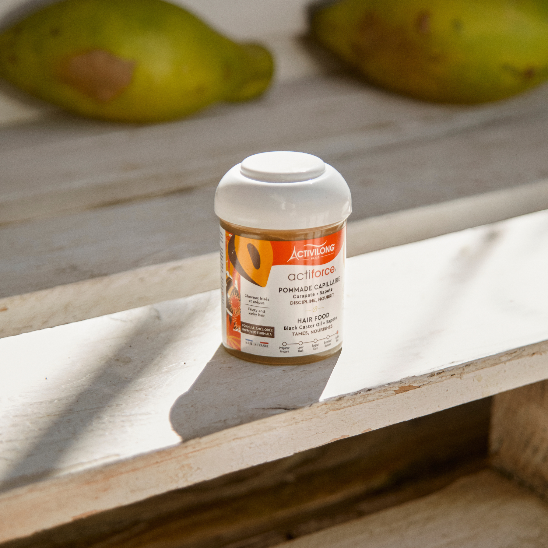 ACTIVILONG ACTIFORCE Pommade Fortifiante 100ml container by ABS France Wholesale on a wooden surface with fruits in the background