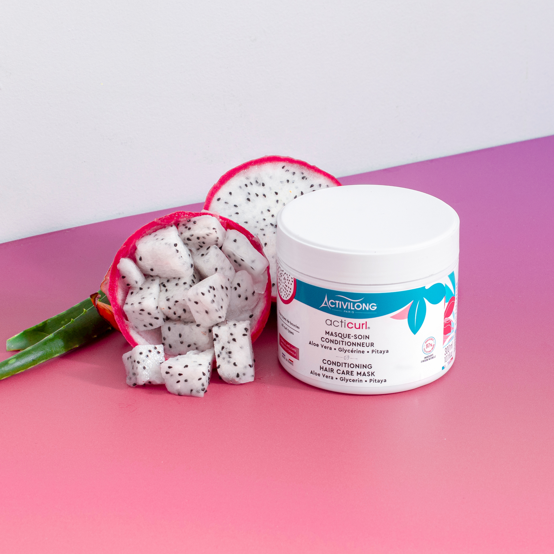 ACTIVILONG ACTICURL Masque 300ml jar by ABS France Wholesale with dragon fruit on a pink surface