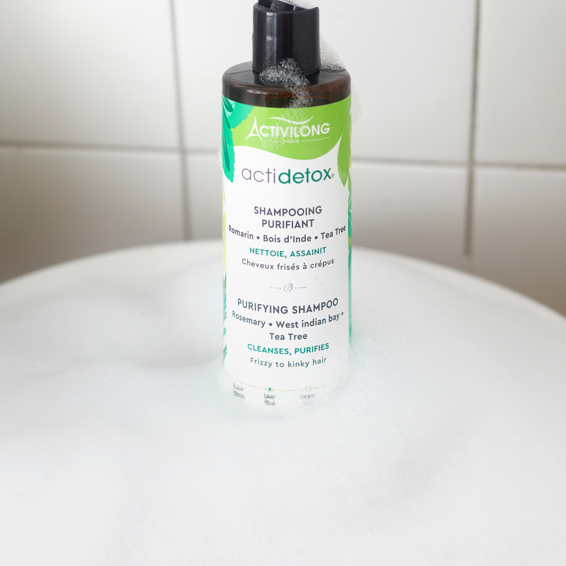 ACTIVILONG ACTIDETOX Shampooing Purifiant 250ml bottle by ABS France Wholesale on a white surface with a tiled wall background.