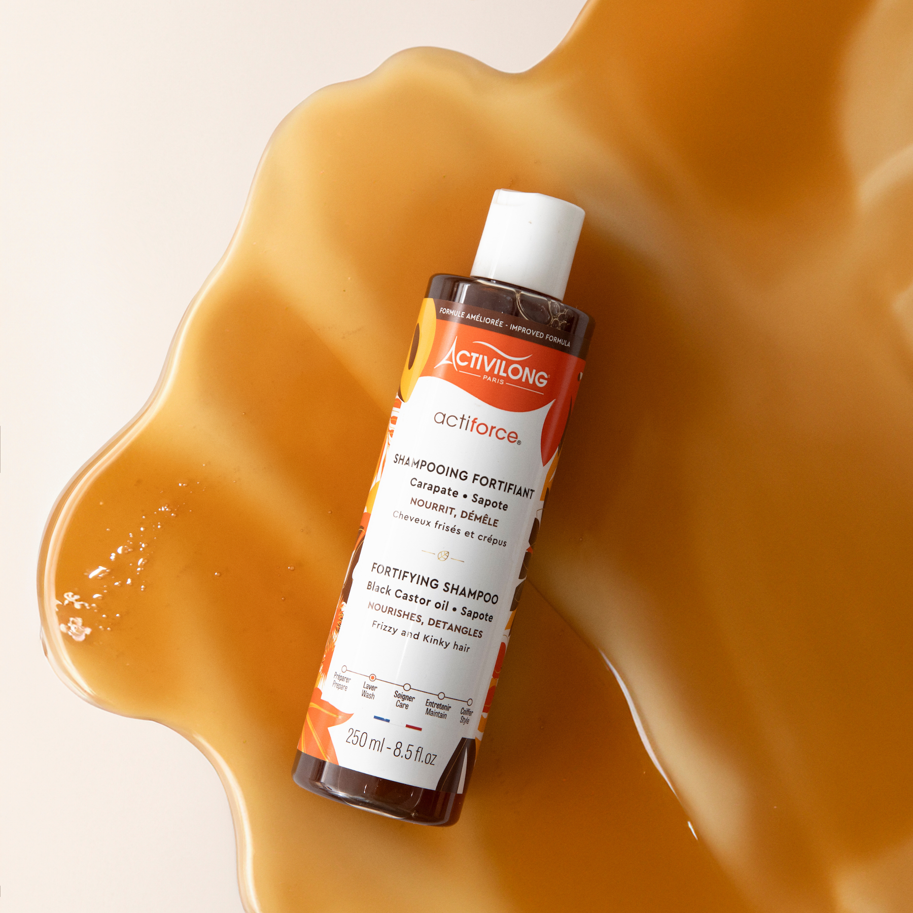 ACTIVILONG ACTIFORCE Fortifiant Shampoing 250ml bottle by ABS France Wholesale on a textured orange background