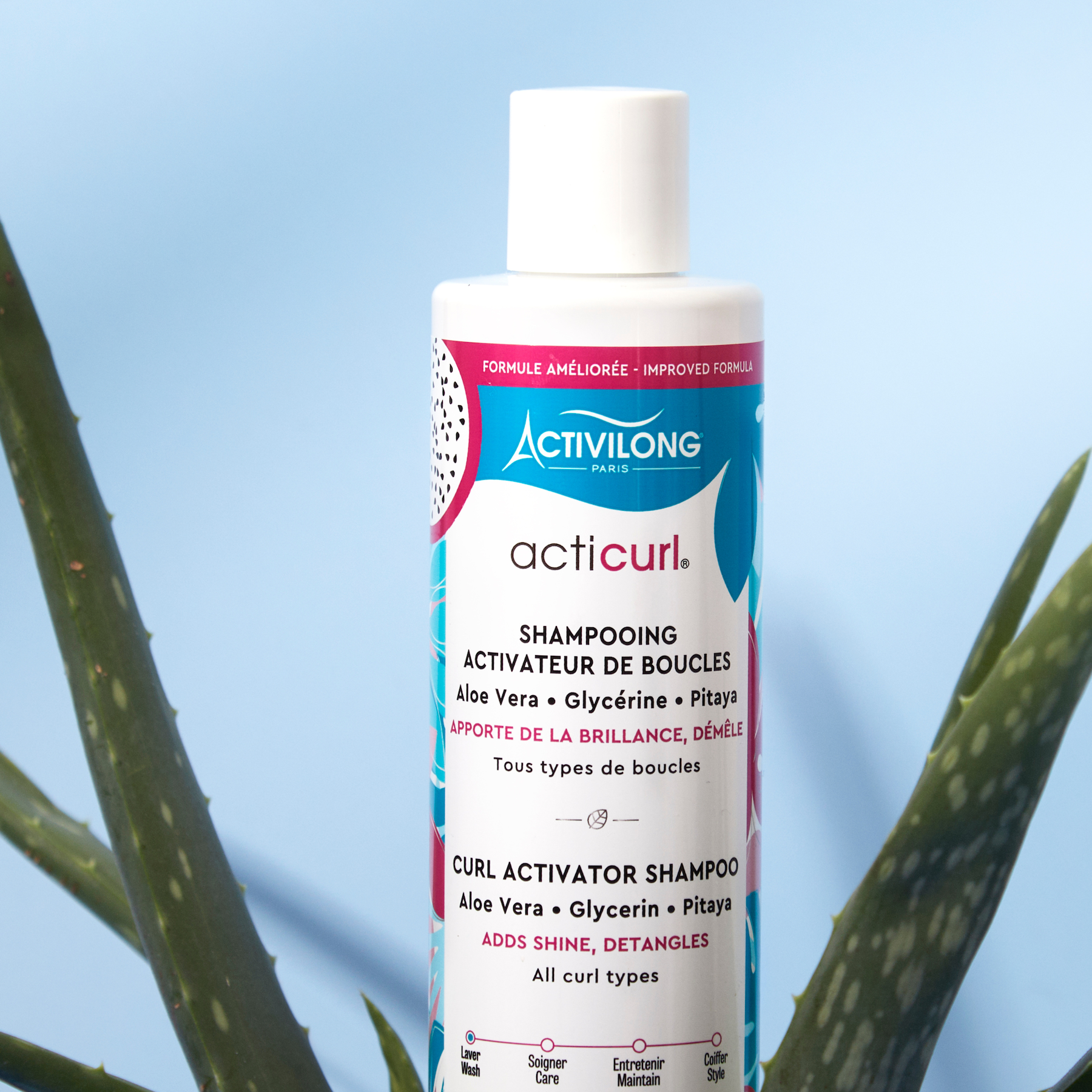 Bottle of ACTIVILONG ACTICURL Shampoing 250ml by ABS France Wholesale with aloe vera leaves in the foreground