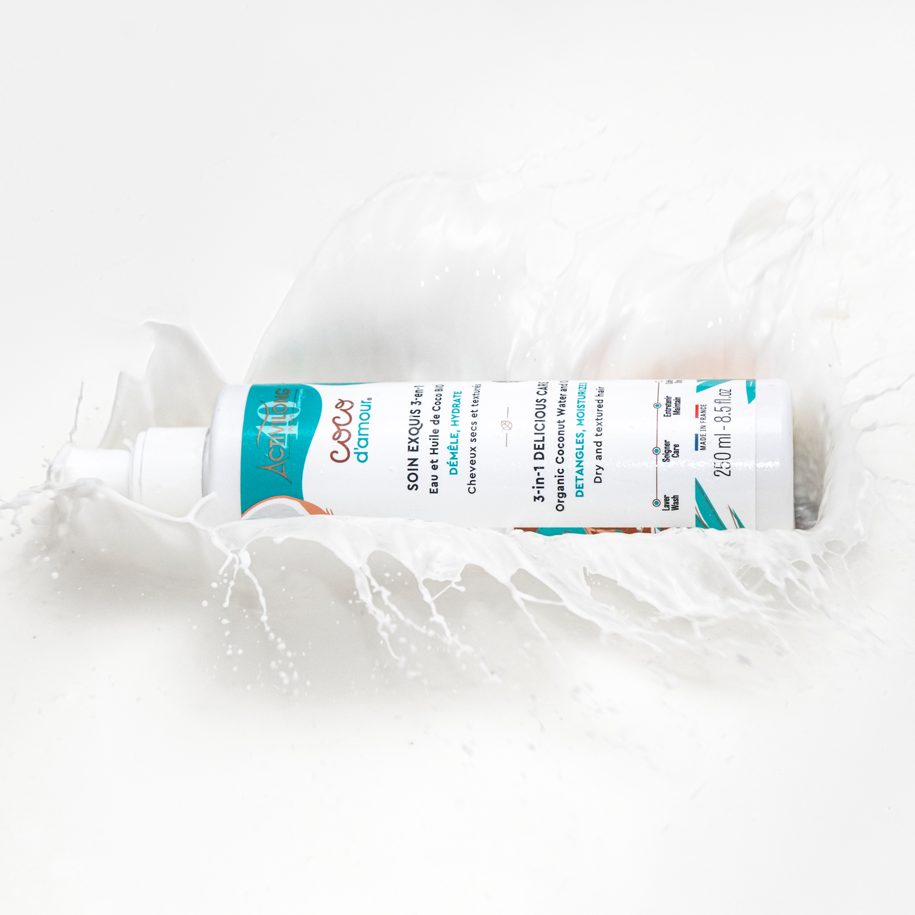 Bottle of ACTIVILONG COCO D’AMOUR Masque Soin Exquis 3-en-1 250ml by ABS France Wholesale on a textured white background